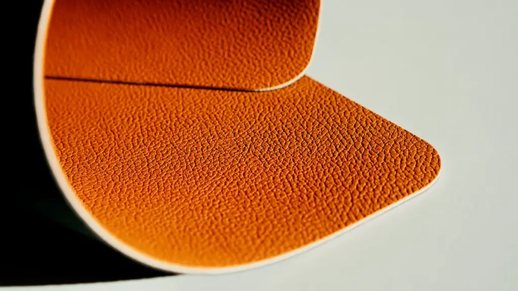 Close-up view of a curved textured brown leather material